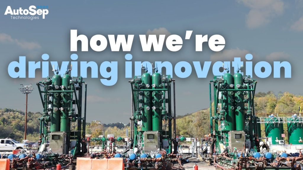 The AutoSep Technologies logo sits in the top left corner of the image. How we're driving innovation if written in blocky white and light blue font in the sky of the image. Below the title are three AutoSep Control Units on an oil rig pad with a green forest tree line in the background.